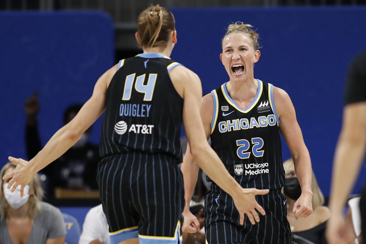 Chicago Sky guard Courtney Vandersloot (22) celebrates with guard Allie Quigley (14) after scoring against the Dallas Wings during the second half in the first round of the WNBA basketball playoffs, Thursday, Sept. 23, 2021, in Chicago.  (Kamil Krzaczynski/Associated Press)