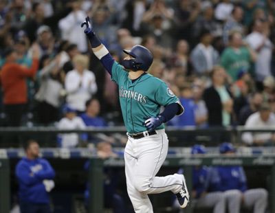 Seattle Mariners' Mike Zunino points as he runs to home plate after hitting a solo home run off Kansas City Royals starting pitcher Ian Kennedy during the fifth inning of a baseball game, Friday, June 29, 2018, in Seattle. (John Froschauer / AP)