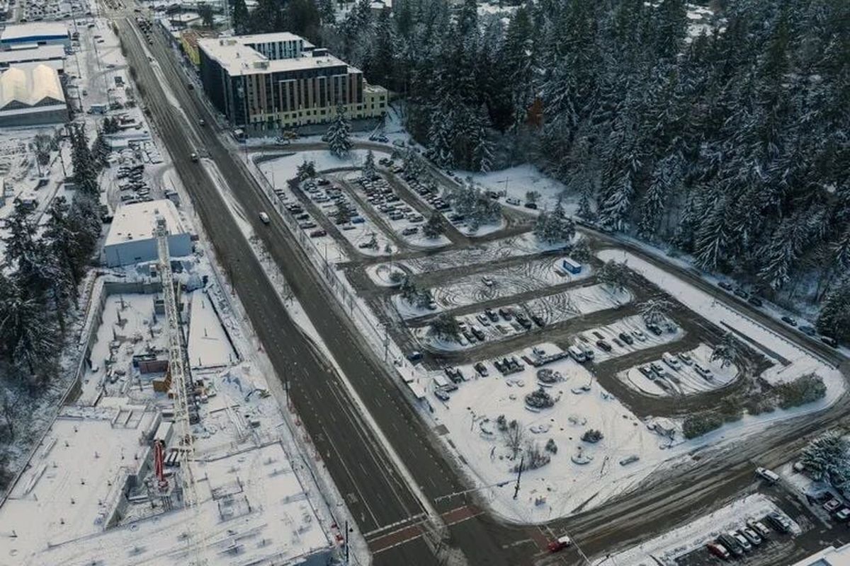 A King County Metro Park and Ride lot in Shoreline, seen from the air Wednesday, has apartment construction projects at top and to the left. The Shoreline City Council has approved zoning changes to help King County Metro redevelop the lot with hundreds of housing units.  (Ken Lambert/Seattle Times)