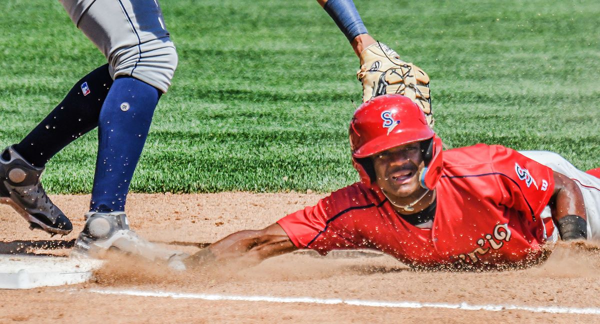 Spokane Indians infielder Julio Carreras dives back into first base on a pick-off attempt during a game against Tri-City at Avista Stadium on Tuesday, August 16, 2022.  (Kathy Plonka/The Spokesman-Review)