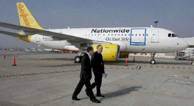 
Chief Executive Officer W.G. Jurgensen, left, of Nationwide insurance company, and Bill Diffenderffer, of Skybus, walk by a Skybus plane to a news conference at Port Columbus in Columbus, Ohio. Fledgling start-up Skybus, scheduled to begin flying this spring, began selling tickets last week. 
 (Associated Press / The Spokesman-Review)