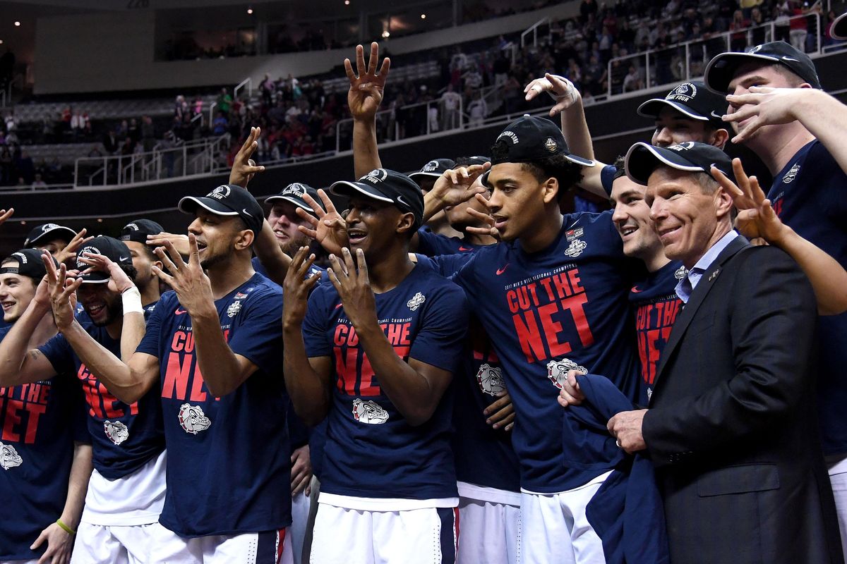 The Zags hold up four fingers representing the Final Four tournament that they are heading in Phoenix the first time in Gonzaga basketball history. (Colin Mulvany / The Spokesman-Review)