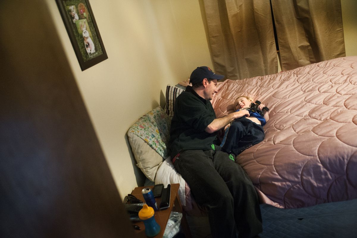 Single father Bobby Moore plays with his 2-year-old son, Marshall, on Tuesday. He has borrowed places to sleep while he searched for where he and Marshall can live. He has applied to rent a dozen different homes, only to be denied. (Tyler Tjomsland)
