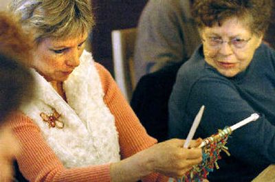 
Ricky Ryan, left, sizes up her knitting project, a summer scarf, while getting comments from Grace Trowbridge, right, during a regular meeting of a knitting group at Bella Rose Coffee in Coeur d'Alene. 
 (The Spokesman-Review)