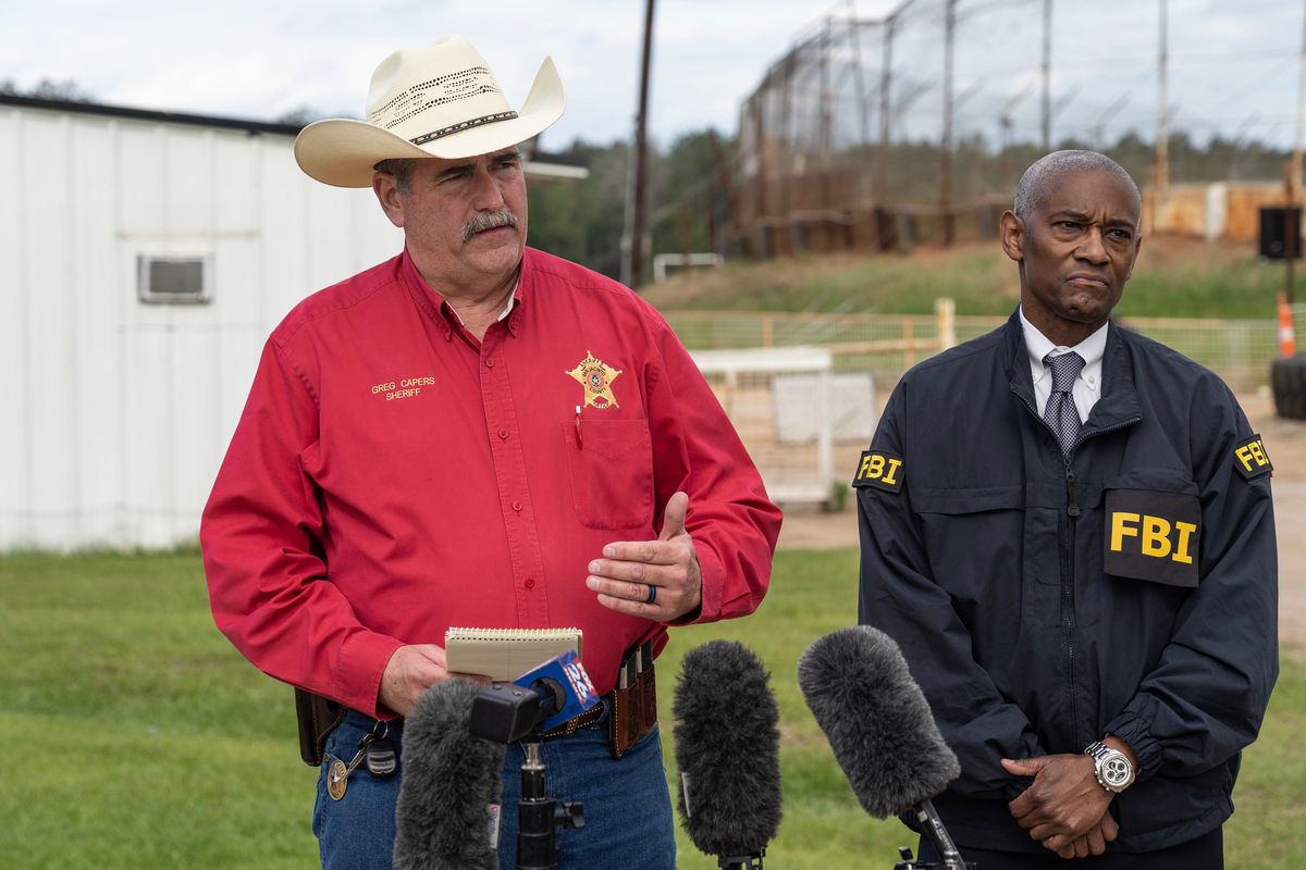 San Jacinto County Sheriff Greg Capers, left, and Special Agent in Charge of the FBI Houston James Smith speak to the media near the crime scene where five people, including an 8-year-old child, were killed after a shooting inside a home on Saturday in Cleveland, Texas.  (Go Nakamura)