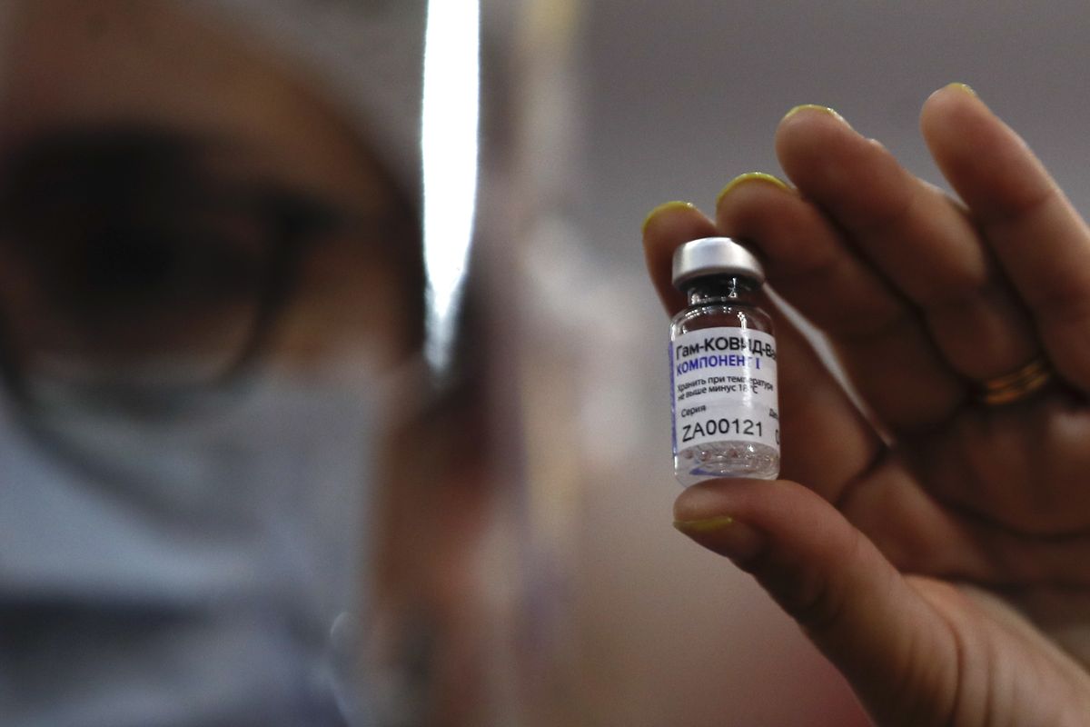 A nurse shows to the press a vial of Russia