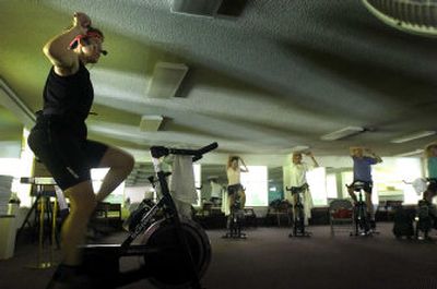 
Kaye Boone warms up her spinning class at the Spokane Athletic Club on Fourth Avenue. Boone lost more than 100 pounds and helps keep it off by teaching the class. 
 (Photos by Jed Conklin / The Spokesman-Review)