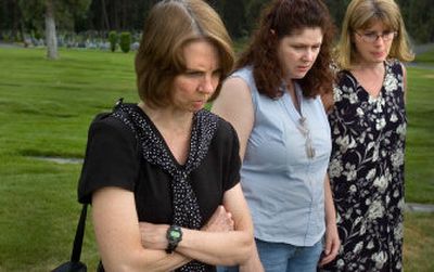 
From left, Spokane County Medical Examiner Dr. Sally Aiken and members of her staff Lorrie Hegewald and Theresa Giannetto look at an unmarked grave.
 (Christopher Anderson / The Spokesman-Review)