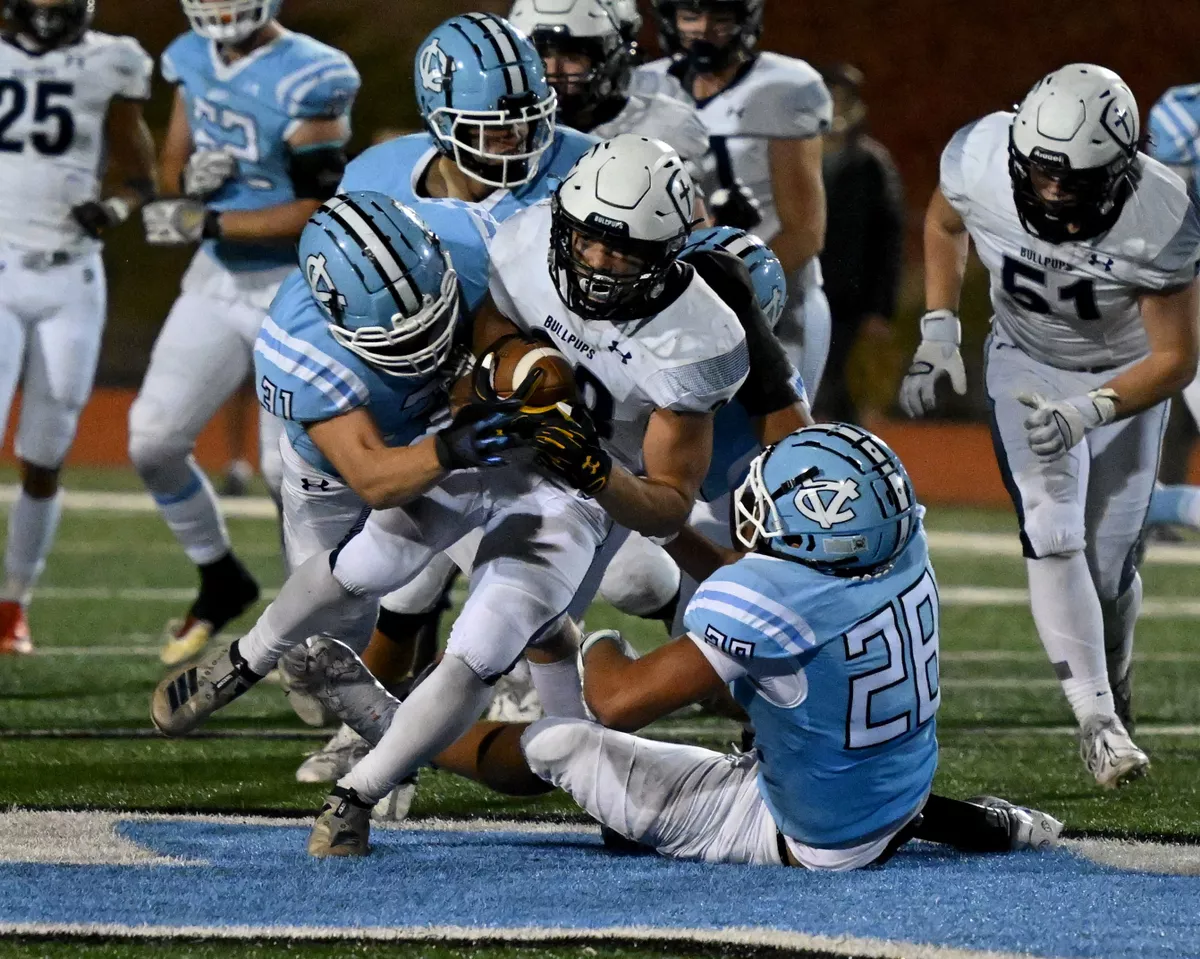 Gonzaga Prep running back Lilomaiava Mikaele (23) is tackled by Central Valley Samuel Cann (31) on left and middle linebacker Brandon Thomas (28) during the first half of a high school football game, Friday, October 14, 2022, at Central Valley High School.   (Colin Mulvany/The Spokesman-Review)