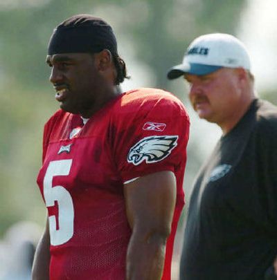
Eagles quarterback Donovan McNabb, left, and coach Andy Reid, right, have learned how to deal with Terrell Owens.
 (Associated Press / The Spokesman-Review)