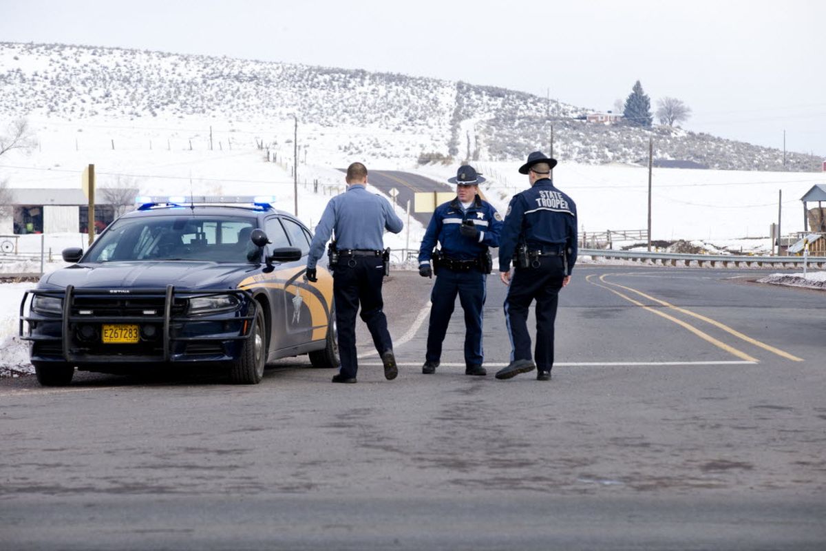 Oregon State Police man a roadblock at the intersection of highways 395 and 20 outside of Burns, Ore., Wednesday morning, Jan. 27, 2016. Authorities were restricting access on Wednesday to the Malheur National Wildlife Refuge headquarters being occupied by an armed group after one of the occupiers was killed during a traffic stop and eight more, including the group