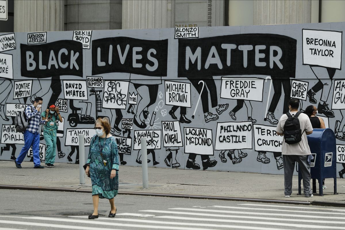 In this June 11, 2020, photo, pedestrians pass a mural in Union Square highlighting police brutality nationwide in New York. More Americans now say police brutality is a serious problem that too often goes undisciplined and unequally targets black Americans. A poll from The Associated Press-NORC Center for Public Affairs Research shows a dramatic shift in the nation’s public opinion on policing and race.  (Frank Franklin II)