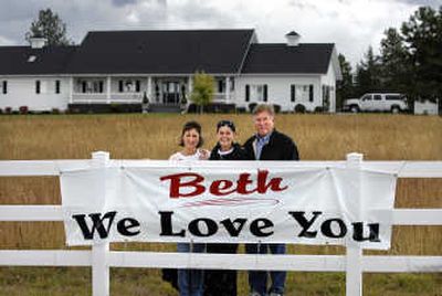 With their neighbors' help, Irene, left, and Ray Young, right, made encouraging signs and posted them along Sands Road in Green Bluff to show support for Ray's daughter, Beth Youngs, center, who has battled esophageal cancer since March. Beth, her husband, Bob, and their two children live next door to Ray and Irene.
(Photo by HOLLY PICKETT / The Spokesman-Review)