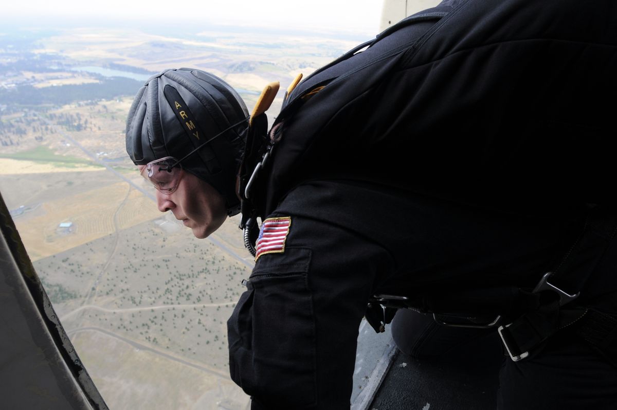 Sgt. Matt Acord, a member of the Army’s Golden Knights parachute team, surveys the landing area  from the door of a C-31 cargo plane on Saturday.  Untimately, shifting winds canceled the jump, which would have opened the day of exhibitions at Skyfest.  (Photos by JESSE TINSLEY / The Spokesman-Review)