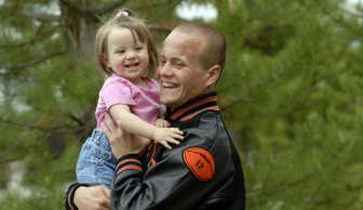 
Post Falls High School graduate Casey Dragon is pictured with his daughter Rylee, 16 months, at the school May 29.
 (Kathy Plonka / The Spokesman-Review)