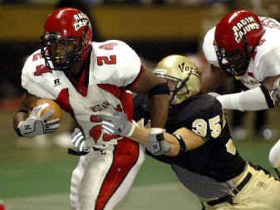 
Idaho linebacker Josh Bousman (35) tries to bring down Louisiana-Lafayette running back Dwight Lindon during the second half Saturday.
 (Associated Press / The Spokesman-Review)
