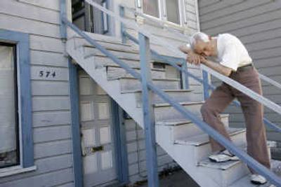 
Jose Morales, 78, rests on the rail on the front staircase of his home. Morales moved into the modest Victorian house in San Francisco's working-class Mission District in 1965, shortly after emigrating from Peru. The rent was $80 a month, and he used leftover earnings to travel, buy nice clothes and eat well. The rent is now $864 _ a bargain by local standards but an unmanageable fortune for Morales. Associated Press photos
 (Associated Press photos / The Spokesman-Review)