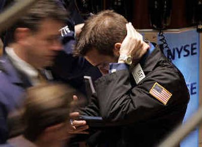 
A trader checks information during trading on the floor at the New York Stock Exchange on Friday. 
 (Associated Press / The Spokesman-Review)