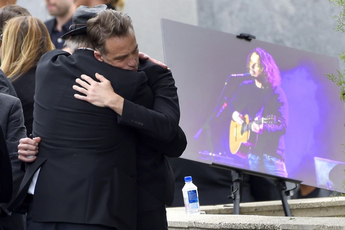 Matt Cameron, of Soundgarden, right, hugs a guest at a funeral for Chris Cornell, pictured right, at the Hollywood Forever Cemetery on Friday, May 26, 2017, in Los Angeles (Chris Pizzello / Associated Press)