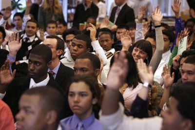 Students respond to a question Wednesday during panel discussion with finance experts at the High School of Economics and Finance in New York. Each student at the school is  following the performance of three stocks of their choosing.  (Associated Press / The Spokesman-Review)