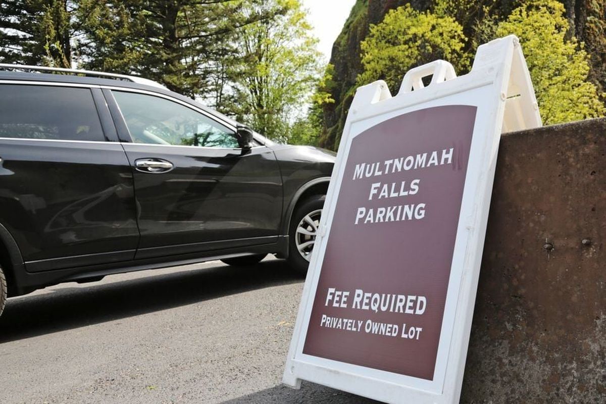 Fee signs are set up in the Sasquatch Shuttle pay lot at Multnomah Falls.  (Jamie Hale | The Oregonian)
