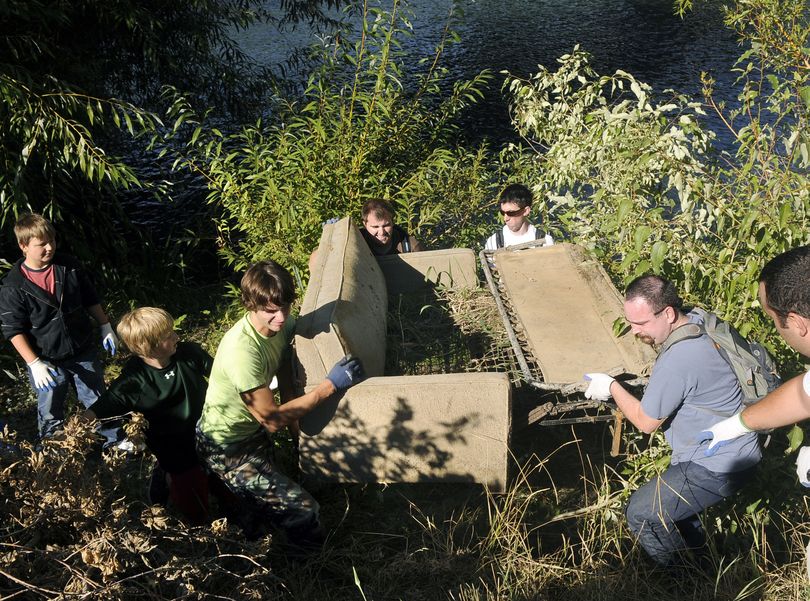 Bubba Ferguson, Tyler Zandhuisen, Chris Lewis, Kaleb Allen, Aaron Danneker and Loren Vanden Berg muscle up a hide-a-bed couch from the banks of the Spokane River near  South Riverton and Desmet during the Seventh Annual Spokane River Clean-Up.  (Dan Pelle / The Spokesman-Review)