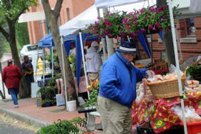 
People check out the offerings at the Cheney Farmers' Market. 
 (Rajah Bose / The Spokesman-Review)