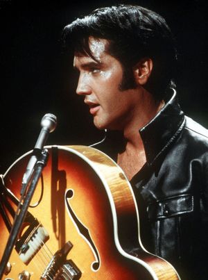 In this December 1968 file photo from the Ullstein archive, Elvis Presley holds his semi-acoustic guitar during a concert.  (Associated Press / The Spokesman-Review)