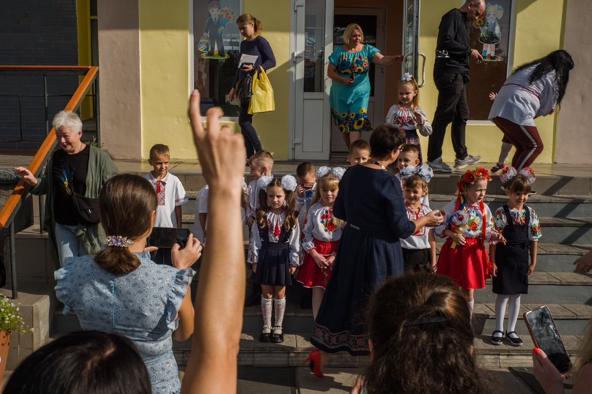 First-grade students in Nove Zalissya, Ukraine, get ready for a class photo on the first day of school. MUST CREDIT: Photo for The Washington Post by Wojciech Grzedzinski  (Wojciech Grzedzinski/For The Washington Post)
