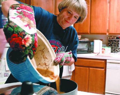 
Benita Galland pours the juices from the crockpot to make gravy after cooking a meal of spare ribs. It's been 32 years since she and her husband, Bob, got the slow cooker as a wedding gift.  
 (Photos by Jesse Tinsley / The Spokesman-Review)