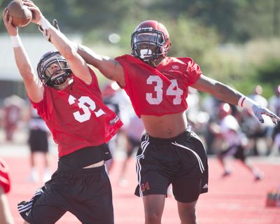 EWU safety safety Zach Bruce (32) snags a ball against teammate Sam Inos during a practice last month. (Tyler Tjomsland / The Spokesman-Review)