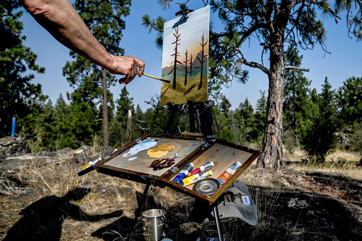 Thor Anderson paints at Q’emiln Park in Post Falls on Friday. He was told that he could not paint in Manito Park by Spokane Parks and Recreation.  (Kathy Plonka/The Spokesman-Review)