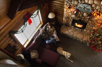 
Jerry and Eliza Shotts, and their dog Gage, in the 1970s kit cabin they transformed into a one-of-a-kind home. 
 (The Spokesman-Review)