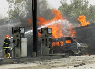 
Firefighters extinguish a fuel tanker that exploded near a gas station in  Baghdad on Wednesday, killing at least 50 people. Associated Press
 (Associated Press / The Spokesman-Review)
