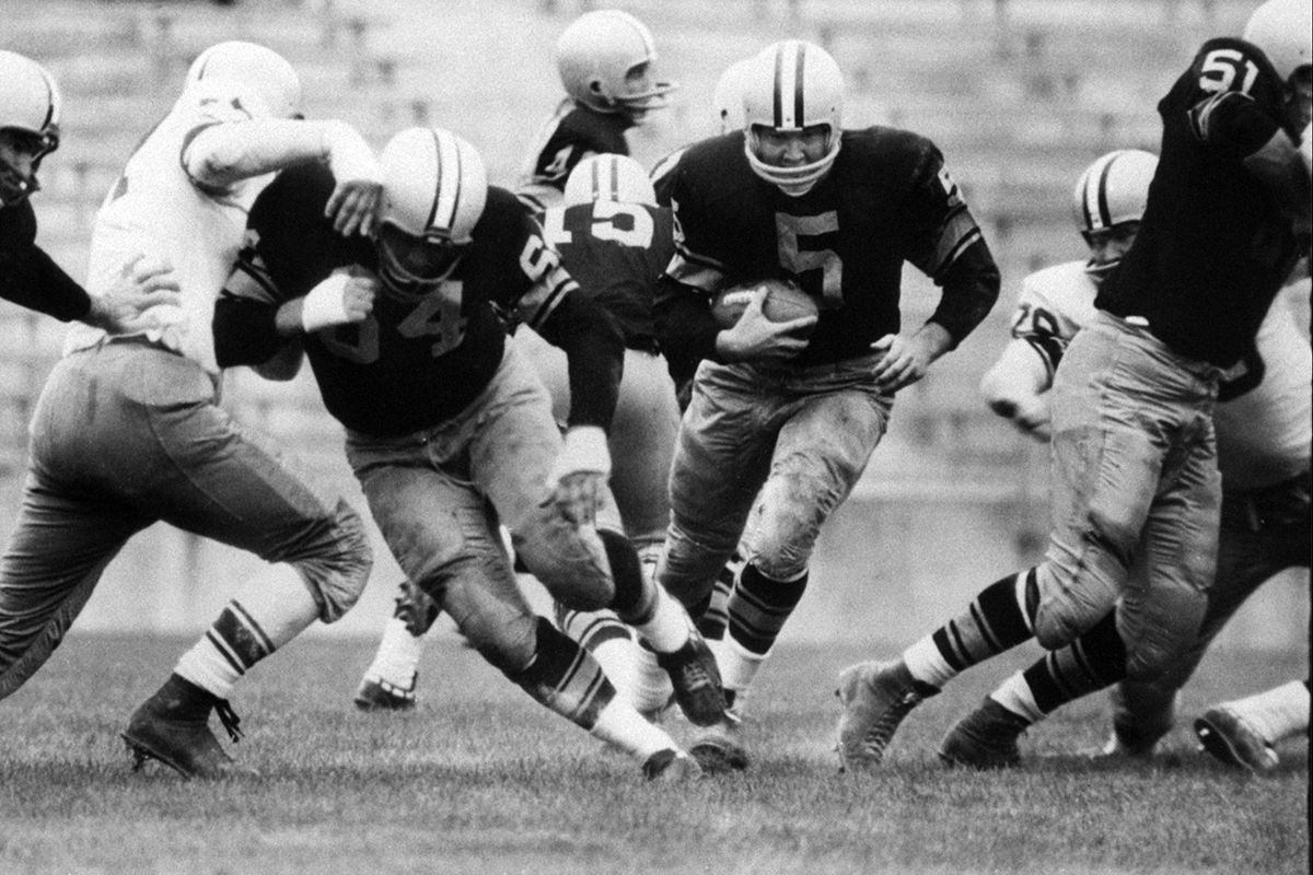 In this Aug. 10, 1959 photo, Paul Hornung (5) of the Green Bay Packers goes through the line in an inter-squad game in Green Bay, Wis. Hornung, the dazzling “Golden Boy” of the Green Bay Packers whose singular ability to generate points as a runner, receiver, quarterback, and kicker helped turn them into an NFL dynasty, has died, Friday, Nov. 13, 2020. He was 84.  (LJG)