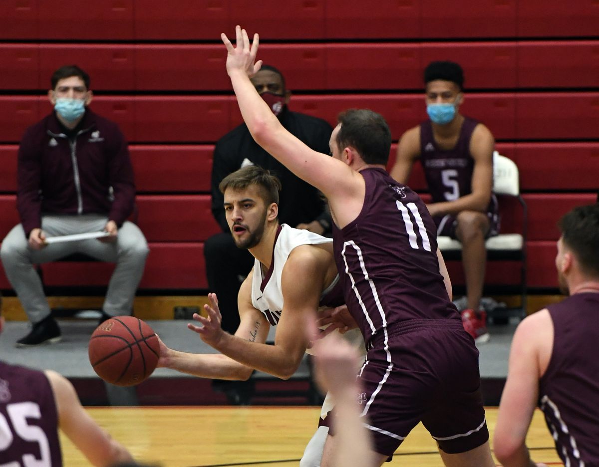 Whitworth Chewy Zevenbergen (40) looks to pass as Puget Sound forward Grant Erickson (11) defends during the first half of a college basketball game, Friday, Feb. 12, 2021, at Whitworth University.  (Colin Mulvany/THE SPOKESMAN-REVIEW)
