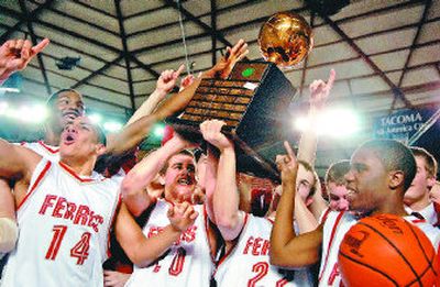 
After surviving double overtime and protecting their perfect record, the Ferris Saxons celebrate their championship trophy. 
 (Holly Pickett / The Spokesman-Review)