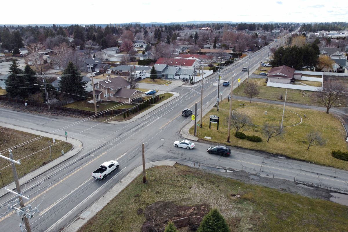 The simple stop sign intersection where Freya Street crosses 57th Avenue on the South Hill will get a roundabout installed to smooth traffic movement along the busy east-west arterial. Shown Friday, Feb. 23, 2024.  (Jesse Tinsley/THE SPOKESMAN-REVIEW)