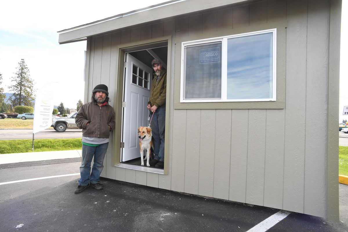 Eric (who declined to provide a last name), left, and Randy Rogers stand by a model tiny cabin, which may soon be built to provide shelter for homeless people like them in North Idaho, as soon as they can secure a place to build a village of the small cabins, shown Wednesday, Sept. 21, 2016 at the corner of Highway 95 and Dalton Ave. The idea of a tiny house village is being pushed by the homeless outreach program of Heritage Health. The men are still homeless. JESSE TINSLEY jesset@spokesman.com (Jesse Tinsley / The Spokesman-Review)