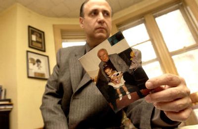 Vito Bruno with a picture of his father. Authorities believe Michael Bruno's body parts were illegally harvested and sold on the black market.
(Associated Press / The Spokesman-Review)