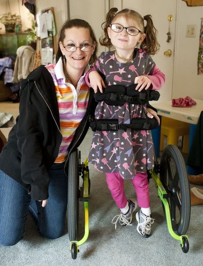 Minute Schwantner’s 7-year-old daughter, Second Merriman, can walk thanks to the people at New Hope Resource Center in Colbert, who helped raise $3,000 for her walker. (Colin Mulvany)