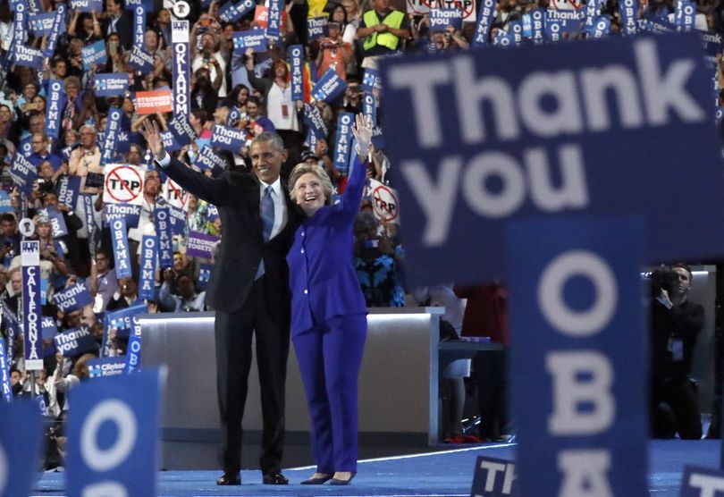 President Barack Obama and Democratic Presidential candidate Hillary Clinton wave together on the third day of the Democratic National Convention in Philadelphia , Wednesday, July 27, 2016. (AP Photo/Paul Sancya)