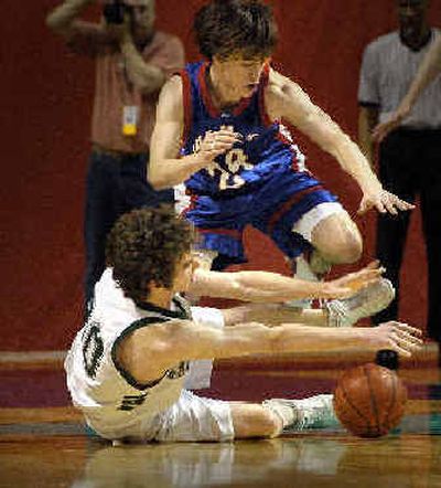 
NWC's Jared McConahy goes to the floor and loses the ball to Garrett Foster of the Vikings. 
 (Christopher Anderson/ / The Spokesman-Review)