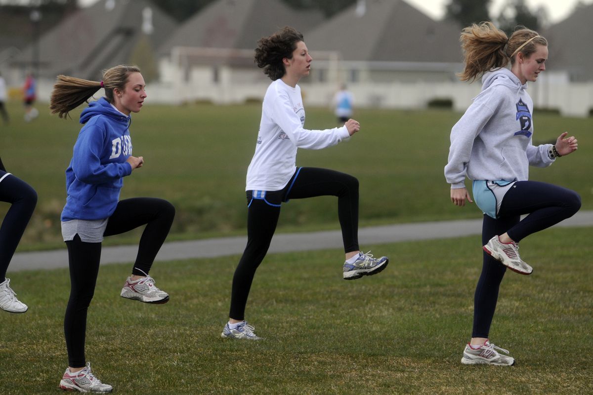 Central Valley High School senior Ashley Renz, center, and her teammates warm up Tuesday. Renz is a Lady Bears team leader and competes in the 800, 1600, triple jump and 4X800 relay. (J. BART RAYNIAK)