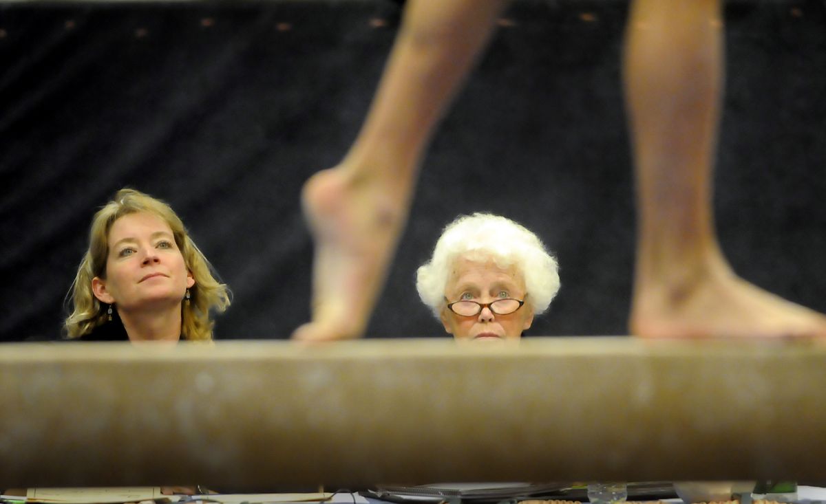 Judges Barbara Elliot, left, and Genie McElroy  watch a teenage gymnast on the balance beam Saturday  at the Great West Gym Fest, a gymnastics competition at the Coeur d’Alene Resort. The event draws more than 1,000 gymnasts and their families for the weekend.  (Photos by JESSE TINSLEY / The Spokesman-Review)