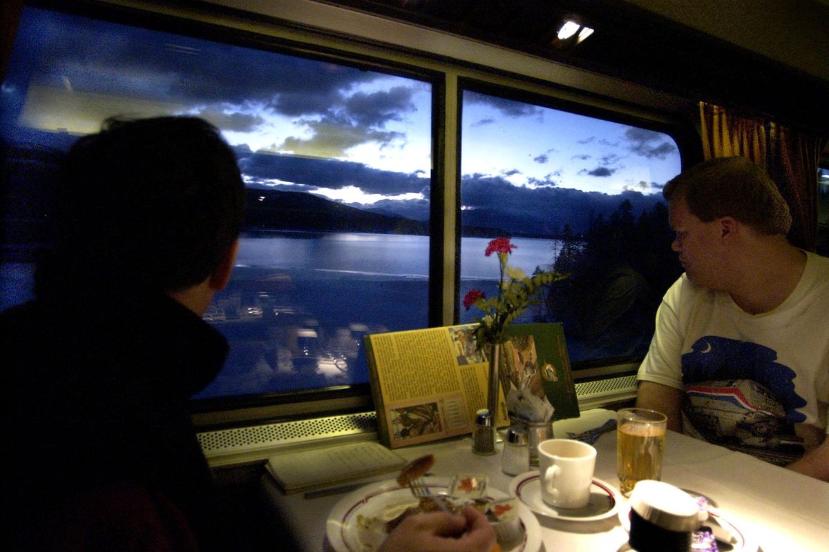 While eating a hearty breakfast in the dining car, eastbound Empire Builder passenger Todd Strausz watches the sunrise near Whitefish, Montana, on February 13, 2002. (Colin Mulvany / The Spokesman-Review)
