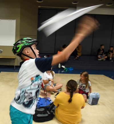 Bemiss Elementary School student Robert Gonzalez launches a paper plane he folded during The SHOP after-school program on Friday, Aug. 30. (Dan Pelle / The Spokesman-Review)