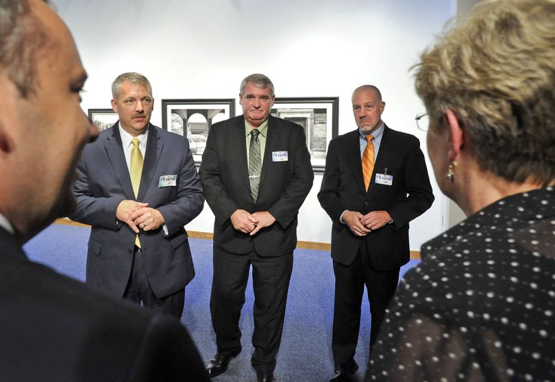 From left facing camera, Spokane Police Chief candidates, George Markert, Daniel Mahoney and Frank Straub, visit with Spokane Mayor David Condon, left, and police historian, Susan S. Walker, during a meet-and-greet Wednesday in City Hall's Chase Gallery. (Dan Pelle)