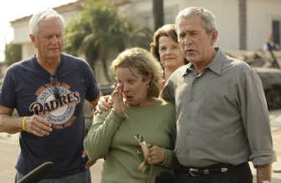 
President Bush meets with Jay Jeffcoat and his wife, Kendra Jeffcoat,  after visiting the remains of their home  Thursday in San Diego. Associated Press
 (Associated Press / The Spokesman-Review)