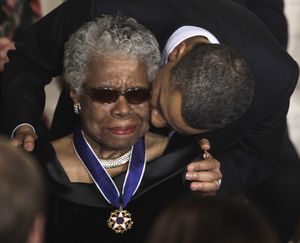 President Barack Obama kisses author and poet Maya Angelou after awarding her the 2010 Medal of Freedom during a ceremony in the East Room of the White House in Washington Tuesday, Feb. 15, 2011. (Charles Dharapak / Associated Press)